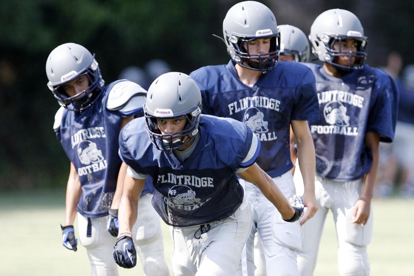 Thomas Turchan, from second left, goes through a drill during practice at Flintridge Prep in La Canada on Friday, August 17, 2012.