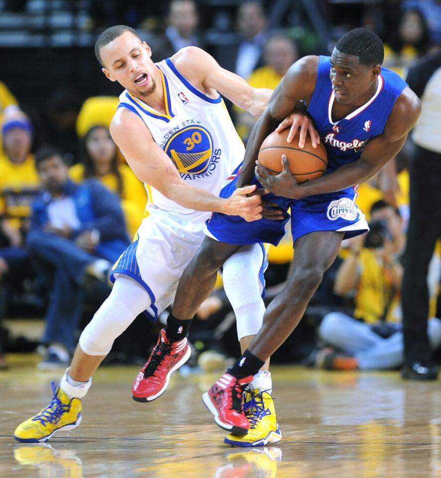 Golden State Warriors point guard Stephen Curry, left, tries to steal the ball away from Clippers point guard Darren Collison during Game 4 of the Western Conference quarterfinals.