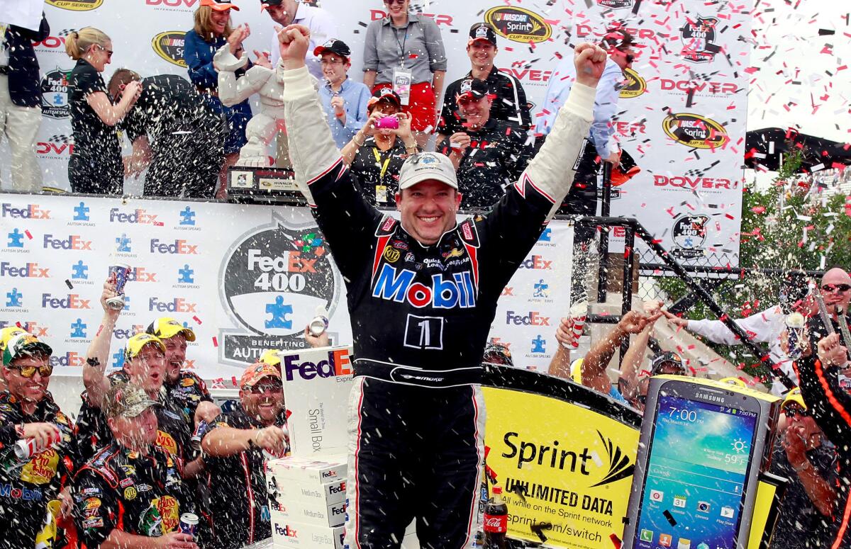 Tony Stewart celebrates in victory lane after winning the FedEx 400.