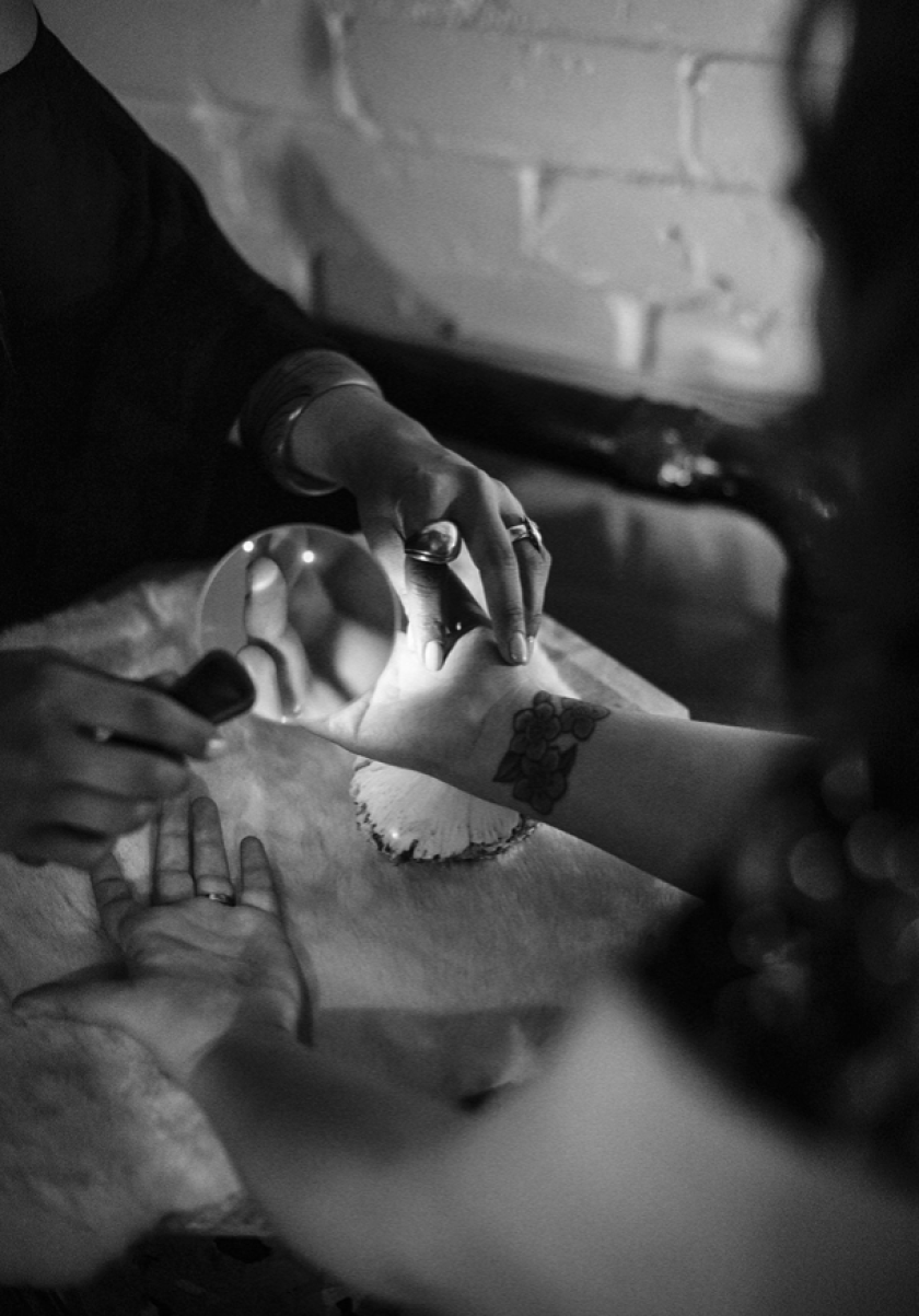 A magnifying glass over an outstretched hand