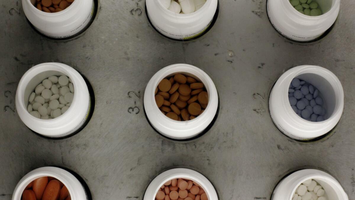 Various prescription drugs on an automated pharmacy assembly line.