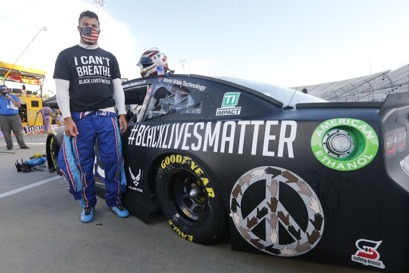 Driver Bubba Wallace waits for the start of a NASCAR Cup Series auto race Wednesday, June 10, 2020, in Martinsville, Va. (AP Photo/Steve Helber)