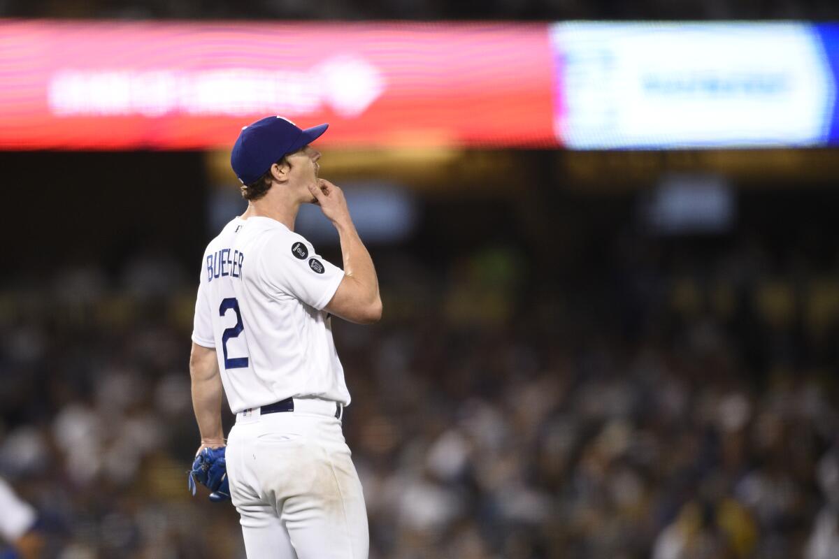 Dodgers pitcher Walker Buehler reacts after allowing a two-run home run to Chicago Cubs' Willson Contreras.