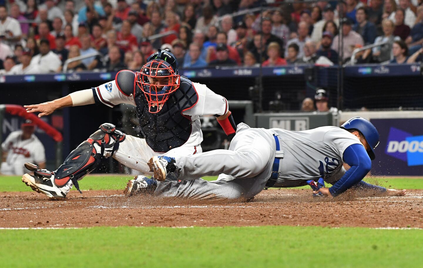 Dodgers Matt Kemp is tagged out by Braves catcher Kurt Suzuki in the 6th inning.