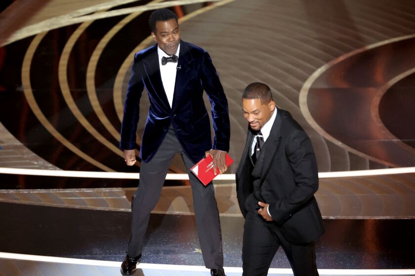 HOLLYWOOD, CA - March 27, 2022. Chris Rock and Will Smith onstage during the show at the 94th Academy Awards at the Dolby Theatre at Ovation Hollywood on Sunday, March 27, 2022. (Myung Chun / Los Angeles Times)