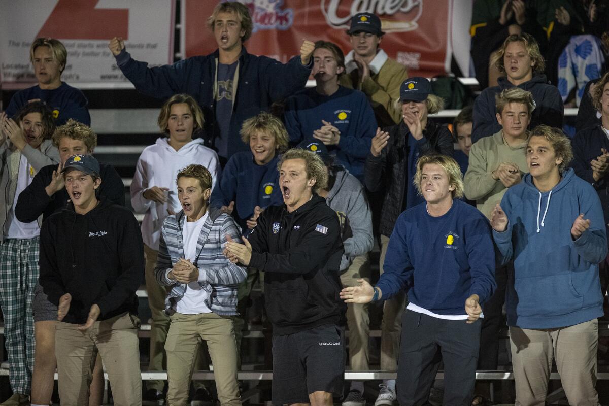Newport Harbor boys' water polo team cheers on the girls' team during Thursday's match.