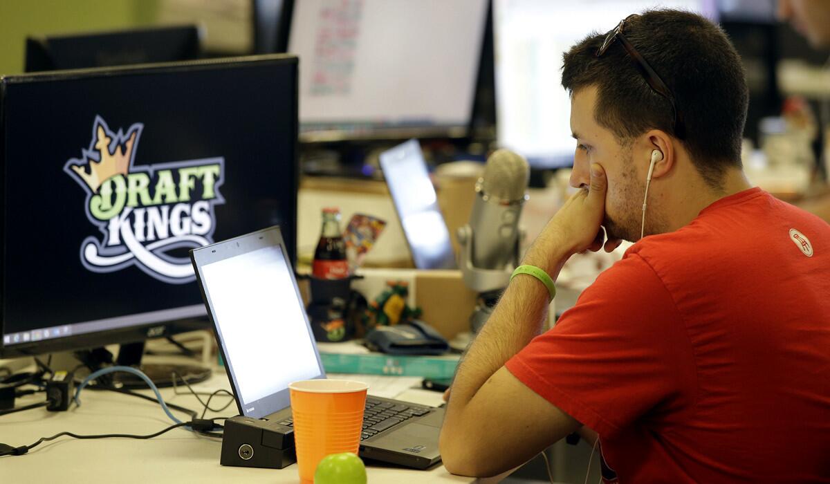 Devlin D'Zmura, a tending news manager at DraftKings, works on his laptop at the company's offices in Boston on Sept. 9.