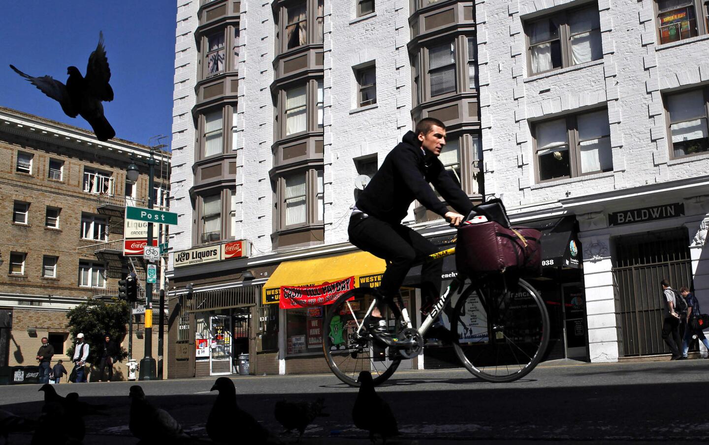 A cyclist wheels down Polk Street. The unique neighborhood byway stretches from the Civic Center to the bay, passing hipster lounges and independent groceries, coffee shops and shoe repair joints, hardware stores and restaurants -- even a sex paraphernalia store with its own vibrator museum.