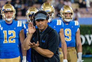 UCLA defensive coordinator Ikaika Malloe reacts on the sideline during a game.