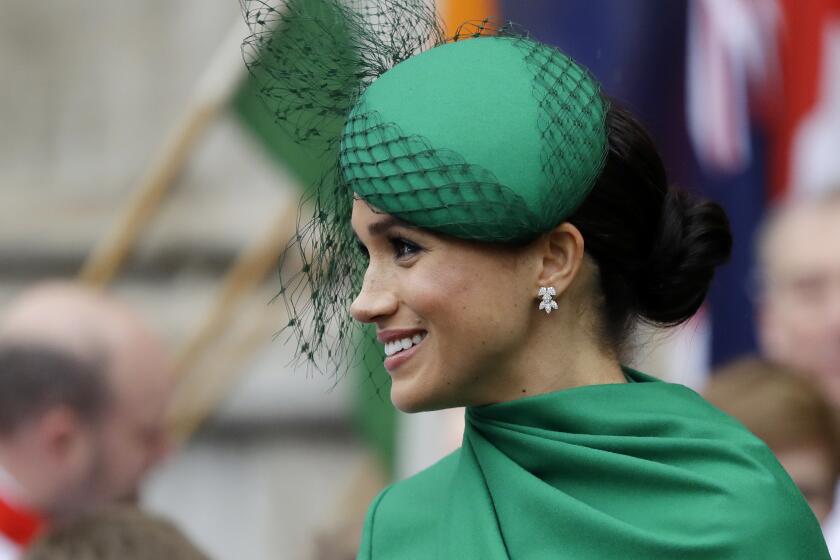 A woman wearing a green hat and dress