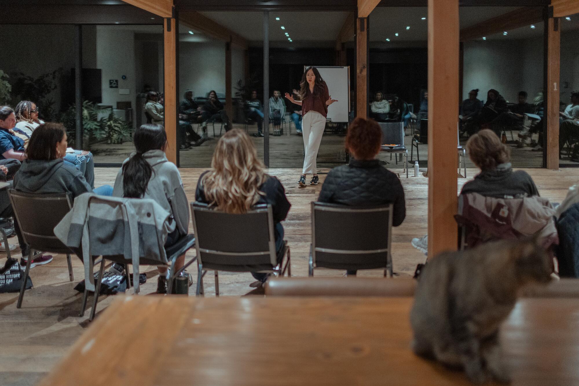 Amy Chan conducts a lecture in front of a group of people.