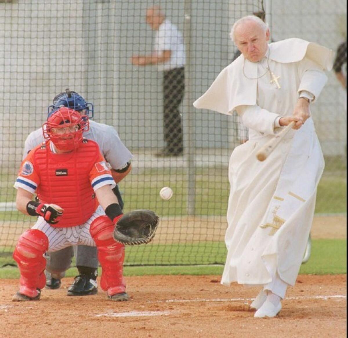 Playing Pope John Paul II, retired real estate broker Gene Greytak takes a swing during a N.Y. Mets fantasy camp in 1996.