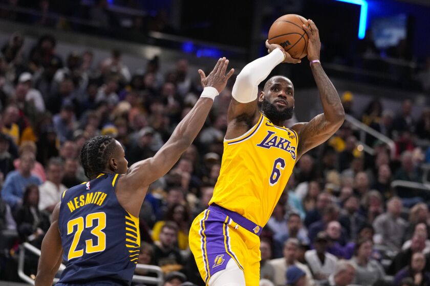 Los Angeles Lakers forward LeBron James (6) shoots over Indiana Pacers forward Aaron Nesmith (23) during the first half of an NBA basketball game in Indianapolis, Thursday, Feb. 2, 2023. (AP Photo/Michael Conroy)
