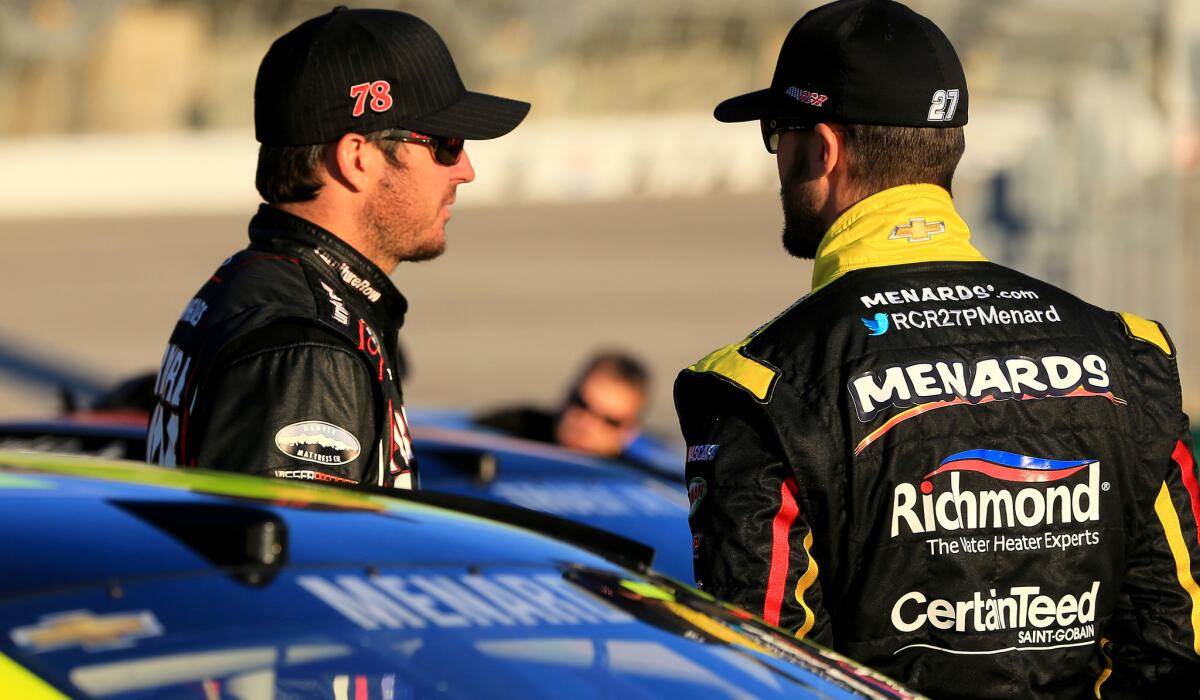 Martin Truex Jr., left, talks to fellow NASCAR driver Paul Menard during a qualifying session in Atlanta last week.