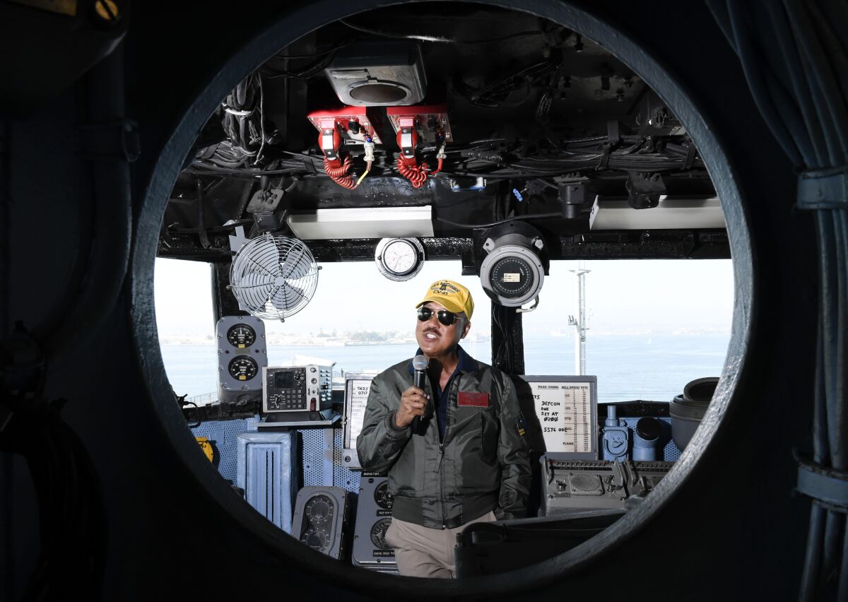 Nguyen Dinh Nguyen, a docent on the Midway, leads a tour on Nov. 13, 2019 in San Diego, California. Nguyen flew Huey's and other aircraft during the Vietnam war.