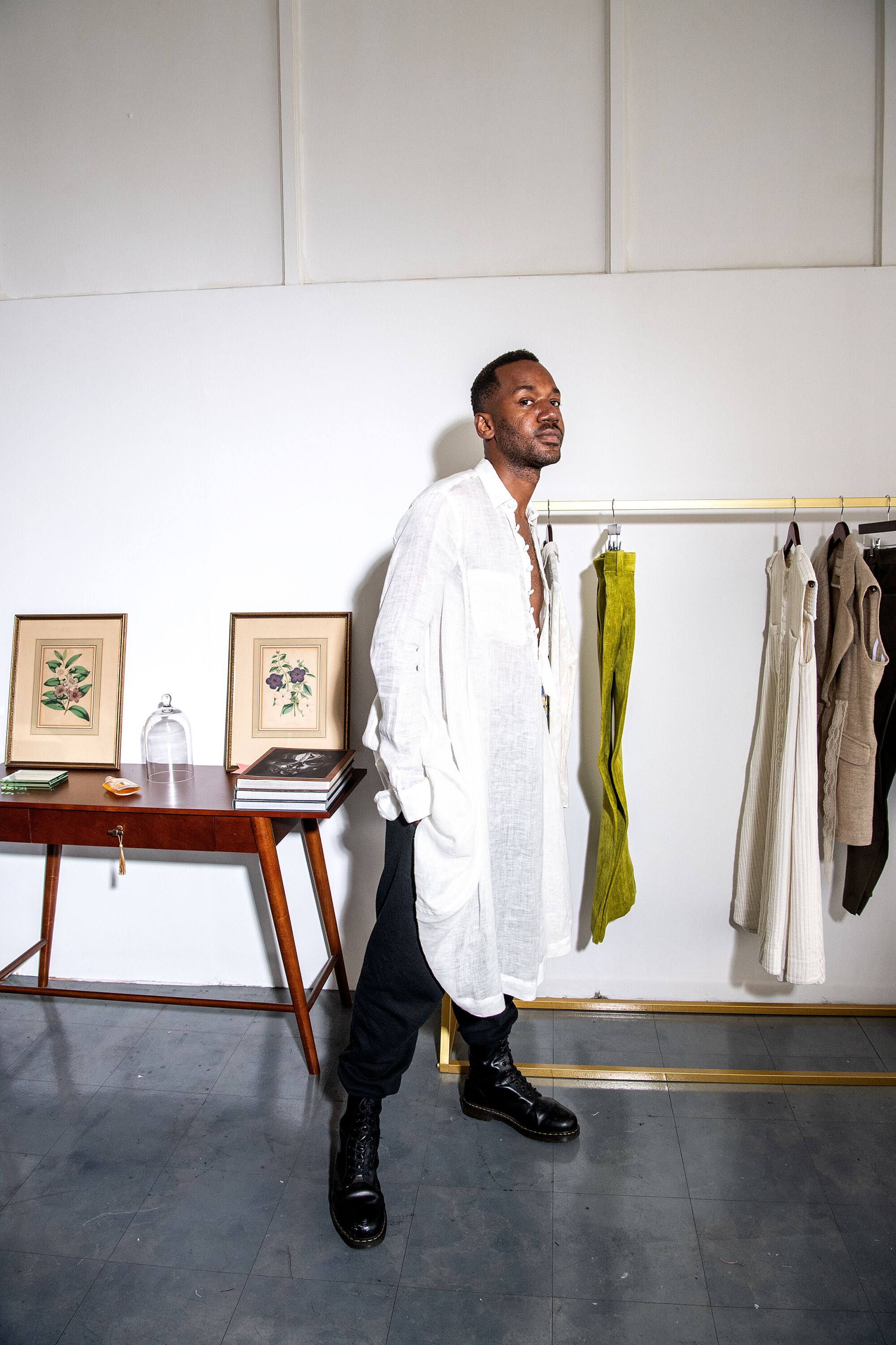 Kenneth Nicholson wears a white gauze Dorcas tunic with paired with black vintage sweatpants.