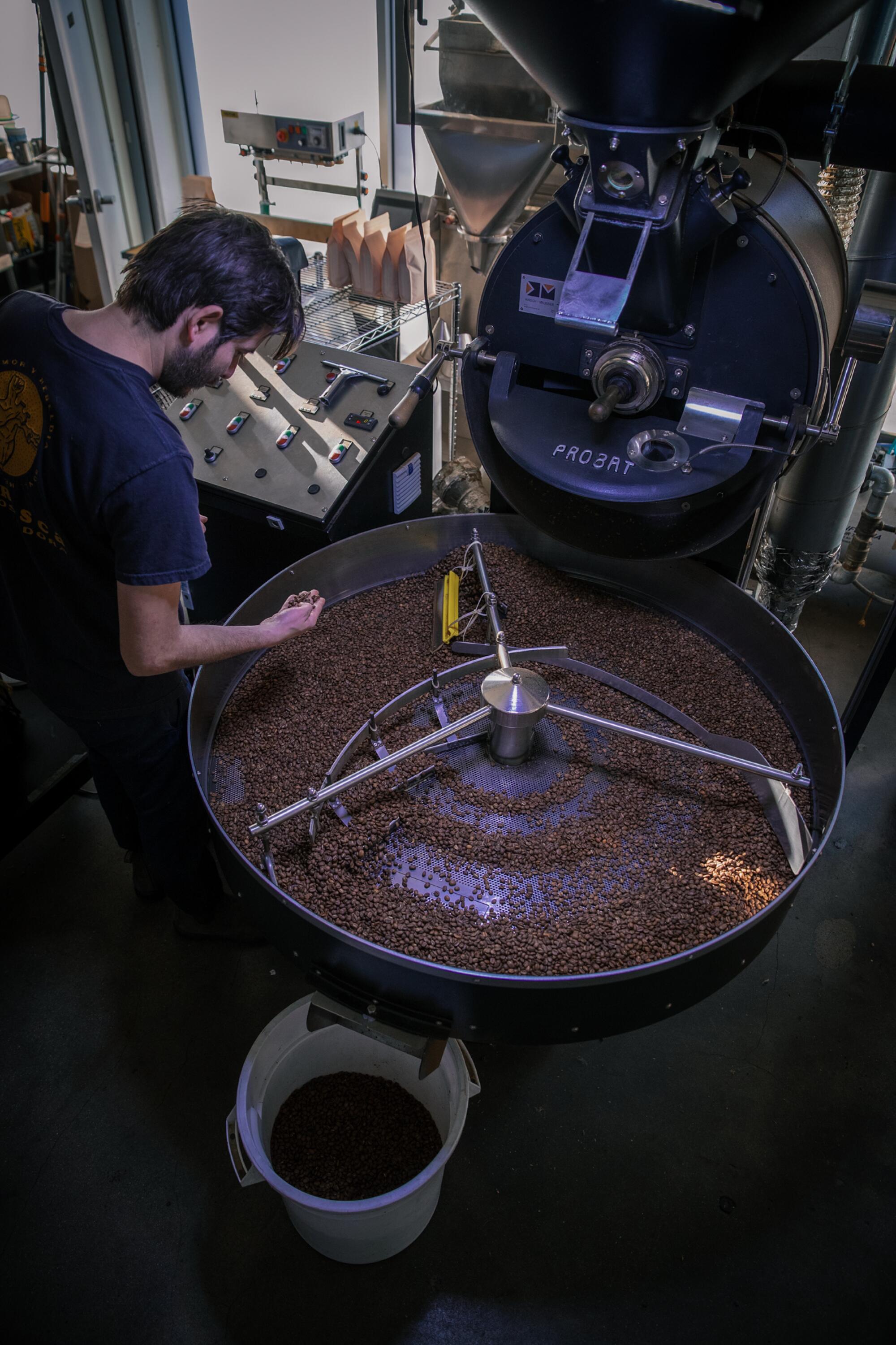 Leonardo Abularach, co-owner of Picaresca, inspects coffee beans while roasting them at Cognoscenti Coffee in Los Angeles.