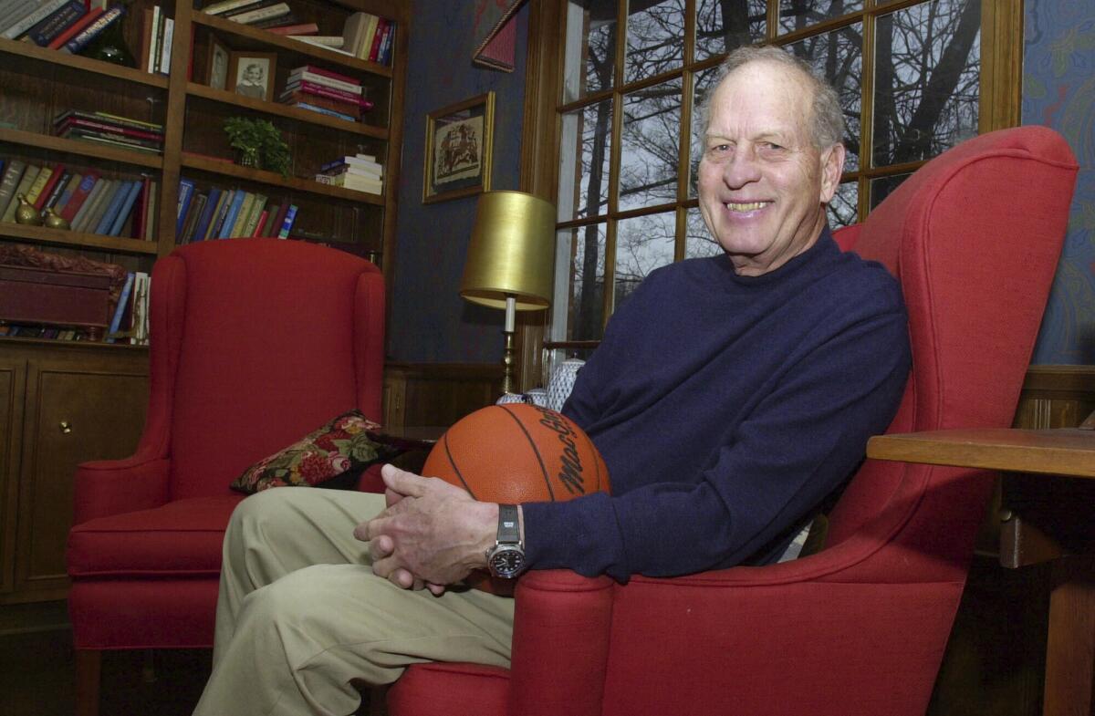 Frank Selvy poses with a basketball while sitting in a chair at his home in 2004.