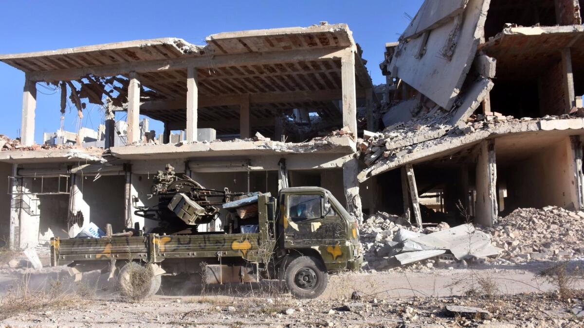 A vehicle of Syrian pro-government forces drives in the Masaken Hanano district in eastern Aleppo. Syrian forces captured the eastern Aleppo neighborhood of Sakhour early Monday.