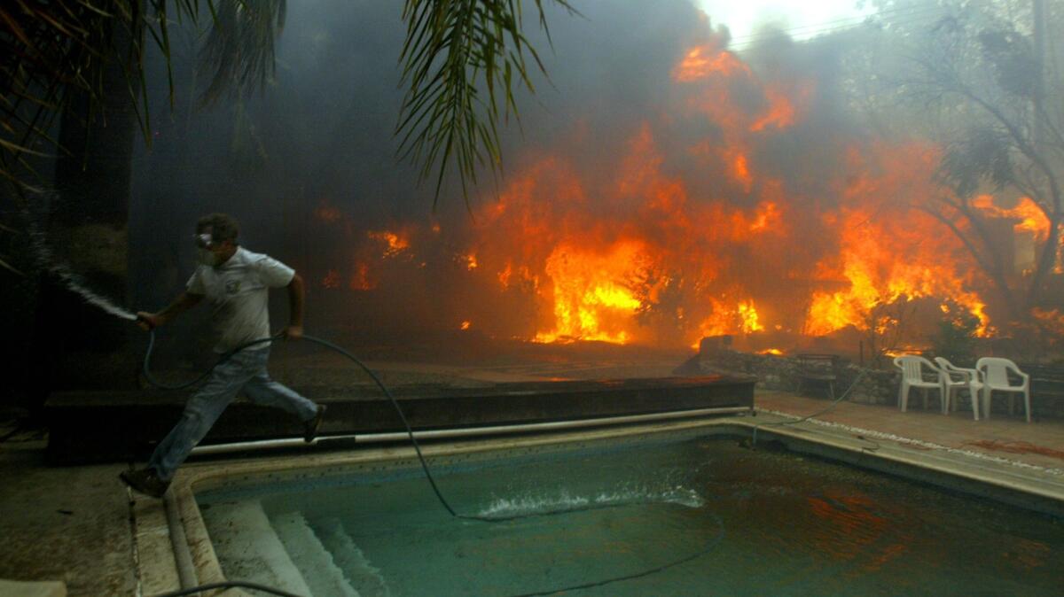 The Old fire swept out of the San Bernardino mountains and destroyed 121 homes in the Del Rosa neighborhood.