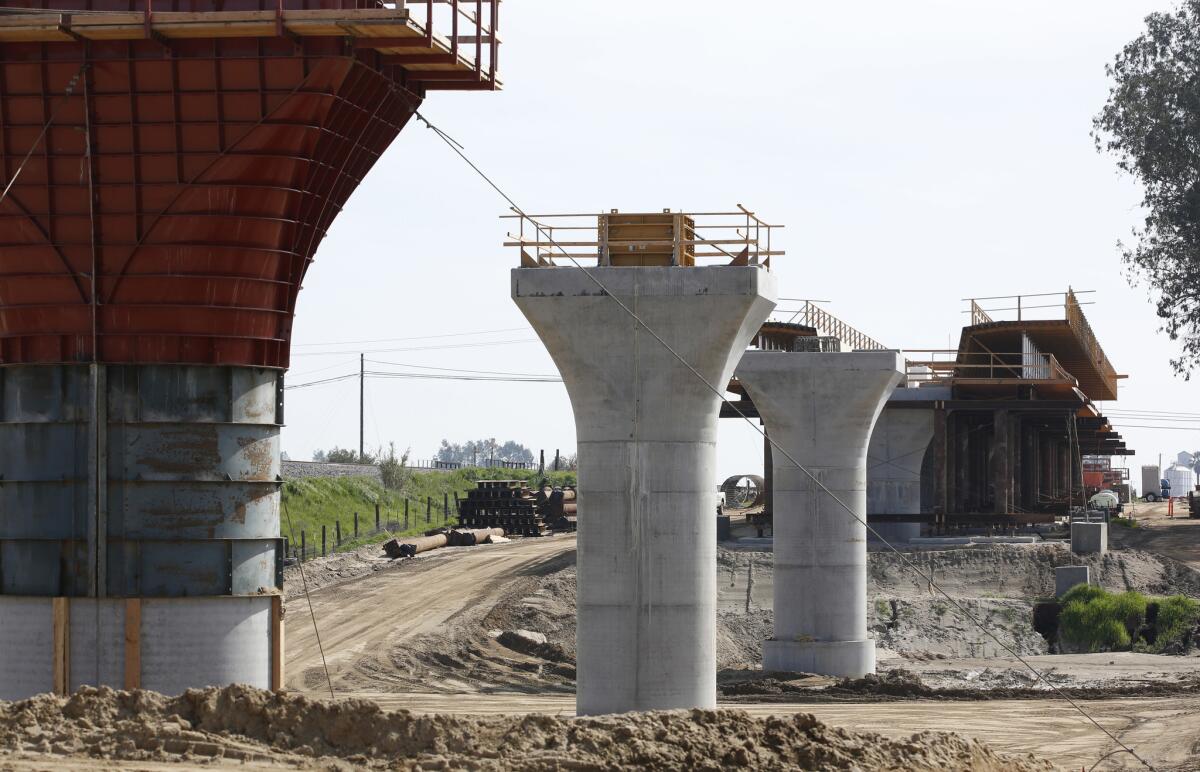 Supports for a 1,600-foot-viaduct to carry high-speed rail trains across the Fresno River are seen under construction near Madera, Calif. Voter signatures are being collected for a November ballot initiative that would shift what’s left of the bullet bonds to water projects.