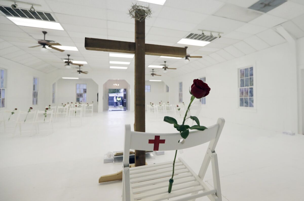 A memorial for the victims of the shooting at Sutherland Springs First Baptist Church includes 26 white chairs, each decorated with a cross and a rose.