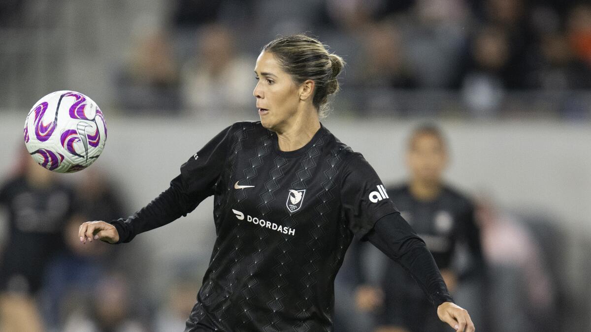 Angel City FC midfielder Katie Johnson controls the ball during an NWSL soccer match.