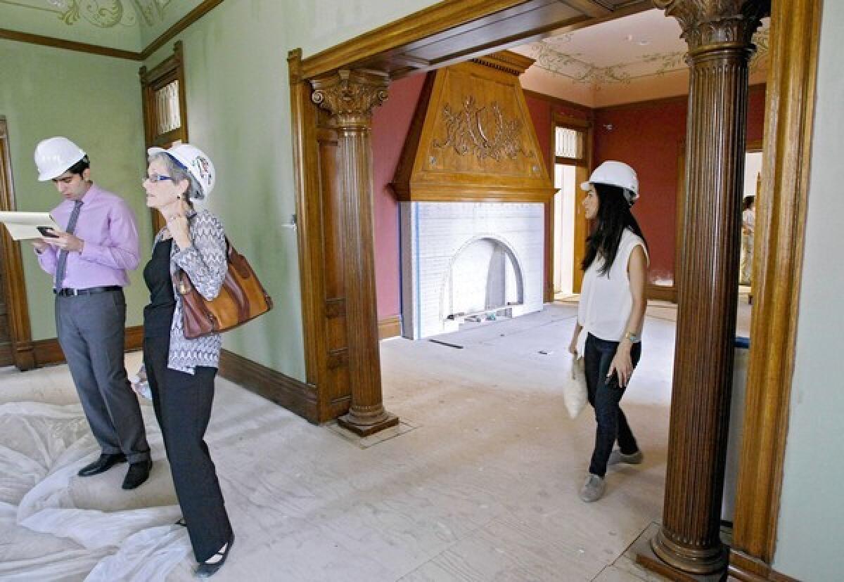 While showing the living room at the Brand Library, City of Glendale Library Administrator Carolyn Flemming, second from left, talks about the renovations and restoration going on at the landmark library in Glendale on Friday, July 19, 2013. The $9.5 million project began in July 2012 and the library will open in the Spring 2014. At right is Brand Library Gallery Director Annette Vartanian.