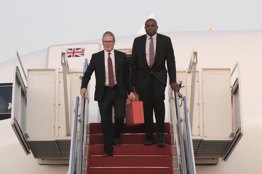 Britain's Prime Minister Keir Starmer, left, and Foreign Secretary David Lammy step from their aircraft as they arrive at Joint Base Andrews, Md., ahead of talks with U.S. President Joe Biden on resolving the conflicts in Ukraine and Gaza, Thursday, Sept. 12, 2024. (Stefan Rousseau/Pool Photo via AP)