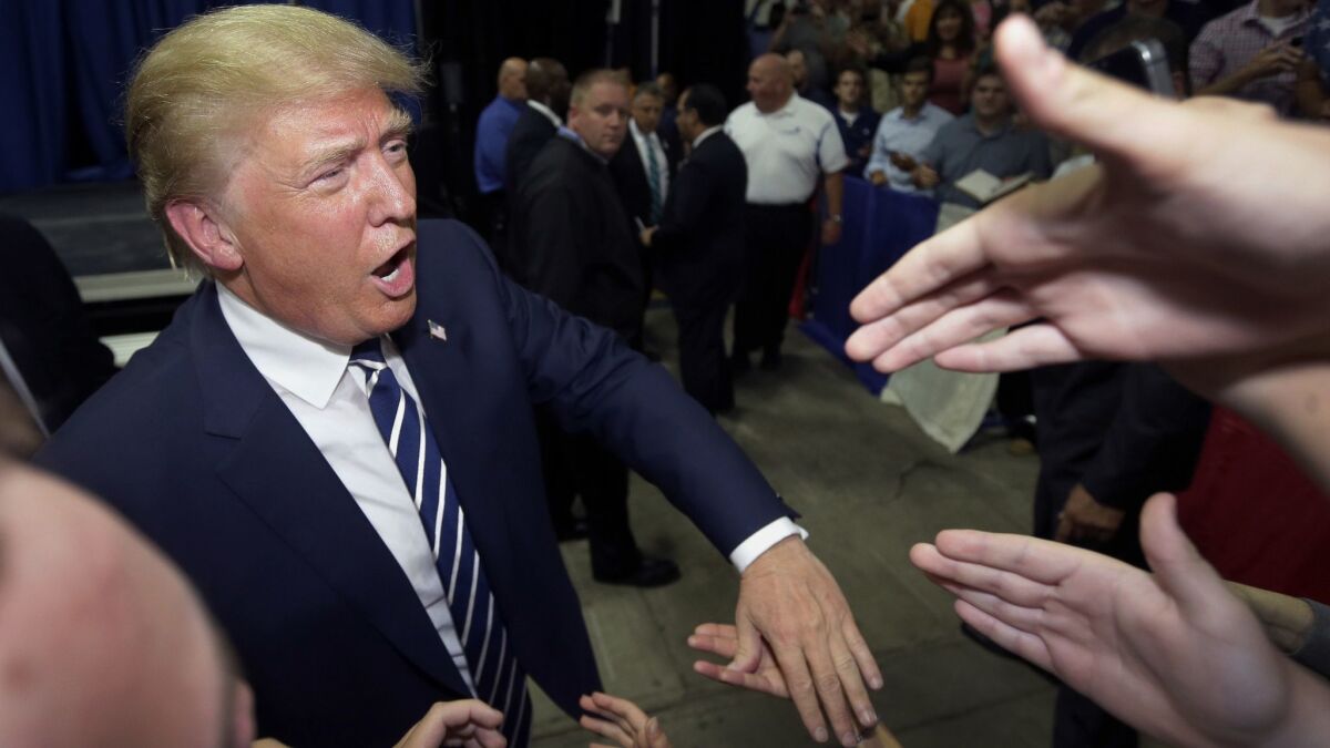 Then-Republican presidential candidate Donald Trump meets supporters in 2015 after addressing a GOP fundraising event in Birch Run, Mich. Trump's reelection campaign will report raising more than $30 million in the first quarter of 2019.