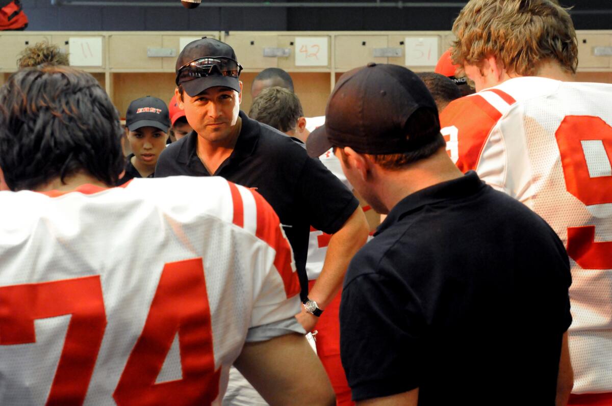 Kyle Chandler as Coach Taylor gives football players in uniform a pep talk in the locker room in "Friday Night Lights."