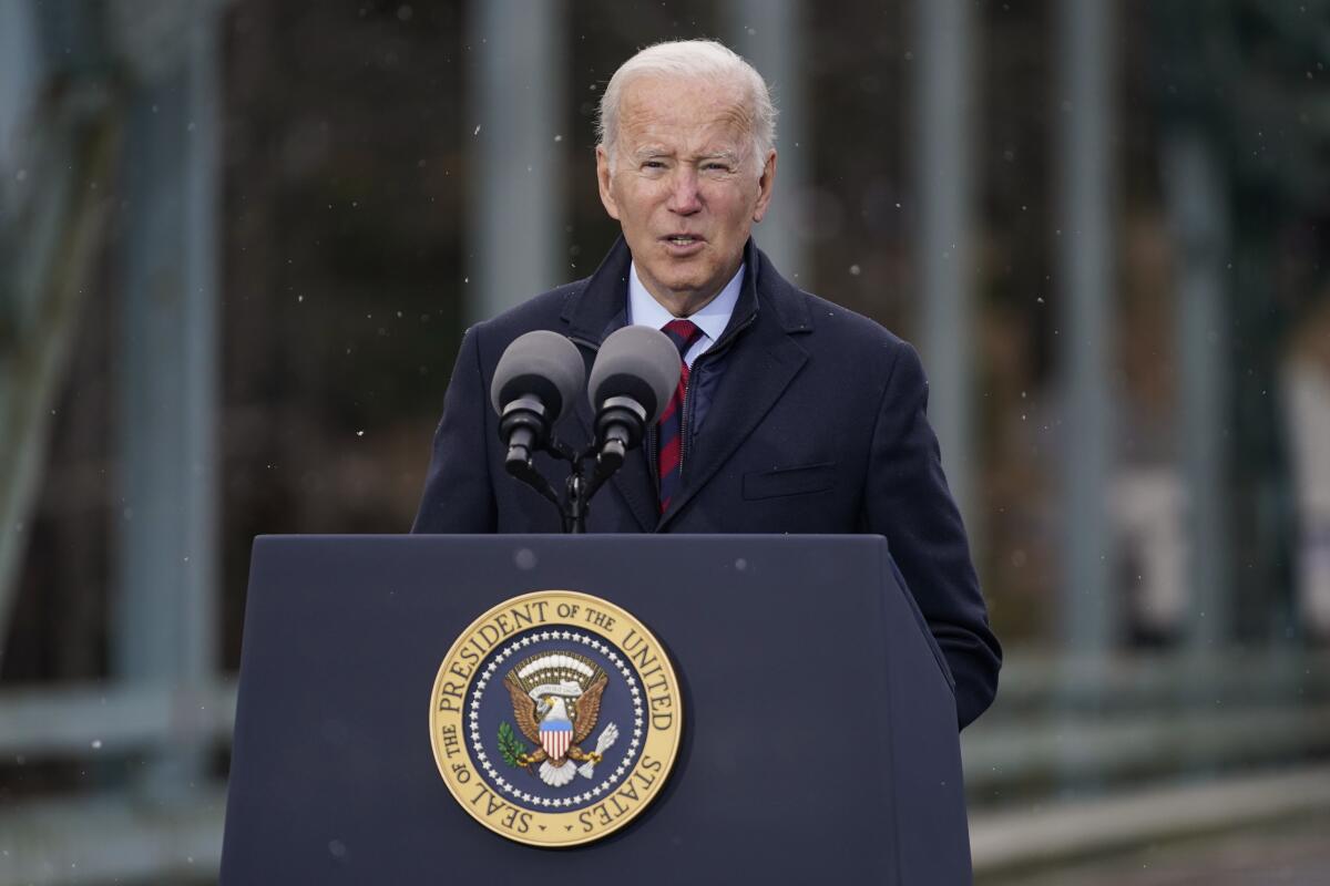 President Joe Biden speaks at a podium at an event