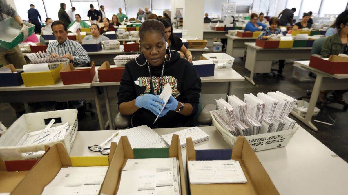 Workers at the Los Angeles County Registrar-Recorder/County Clerk go through absentee ballots in Norwalk, Calif. on Nov. 13, 2018.