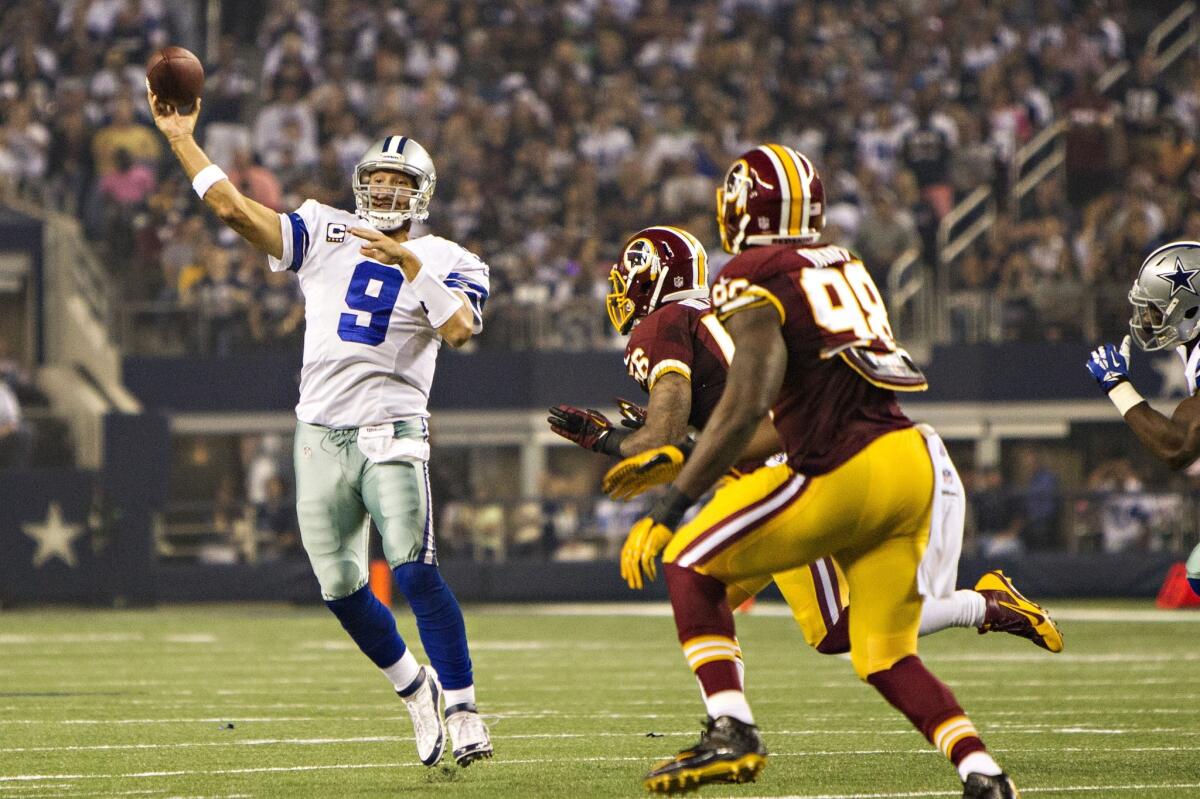 Tony Romo of the Dallas Cowboys throws a pass under pressure against the Washington Redskins on Sunday night.