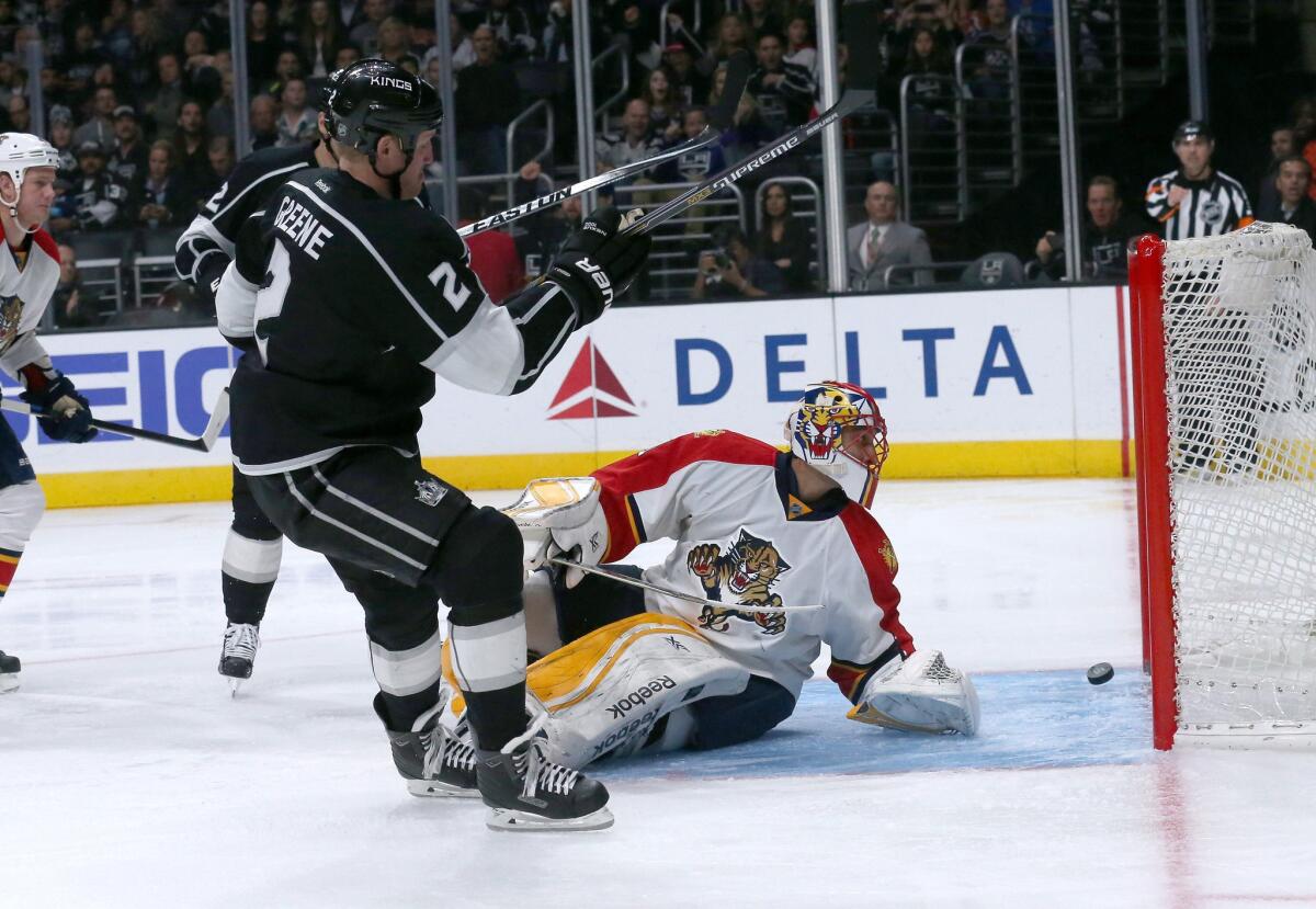 Defenseman Matt Greene slips the puck past Florida goalie Roberto Luongo during the second period of the Kings' 5-2 win over the Panthers at Staples Center on Nov. 18.