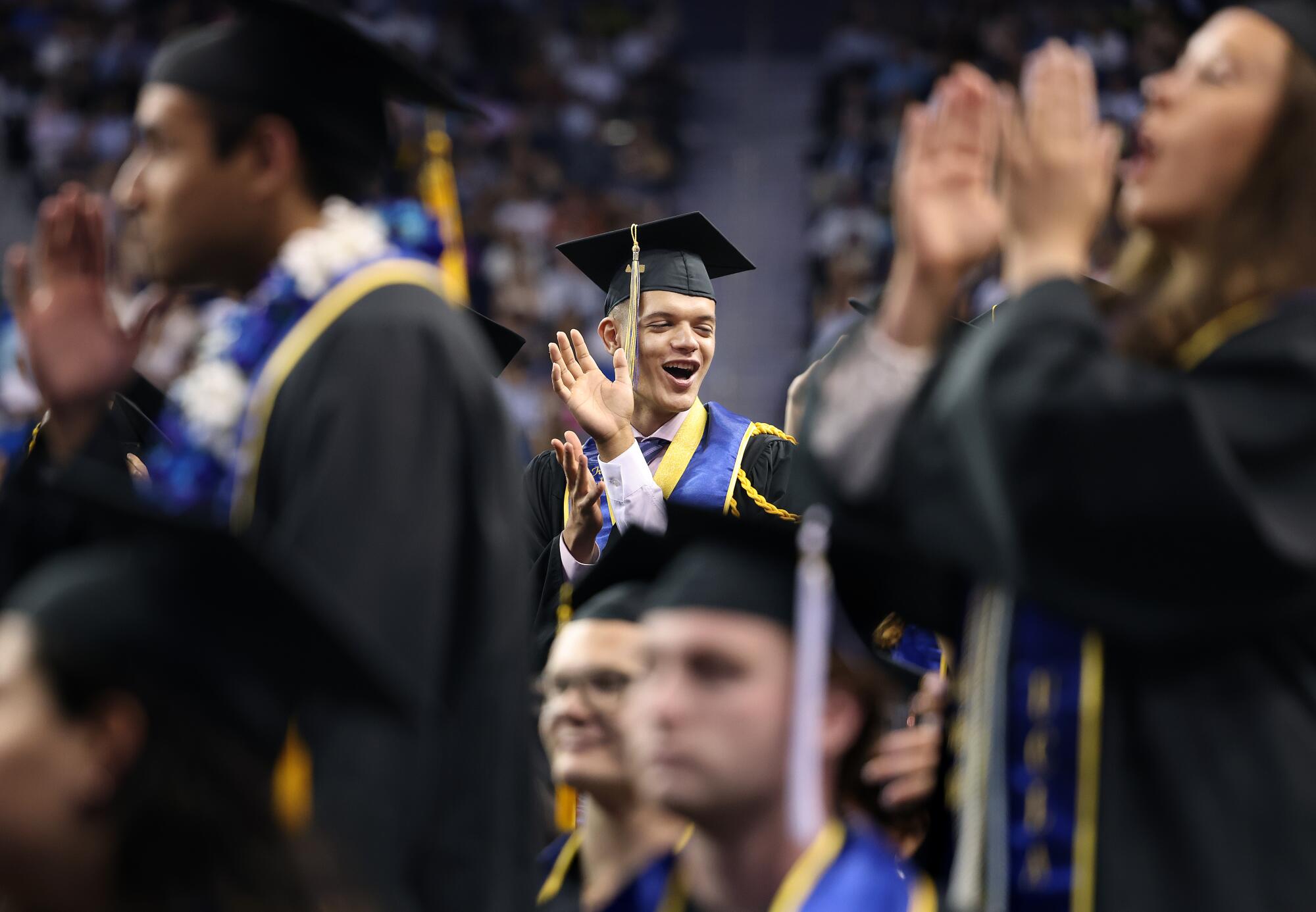 Graduates celebrate at their commencement ceremony for the College of Arts and Sciences at UCLA's Pauley Pavilion.