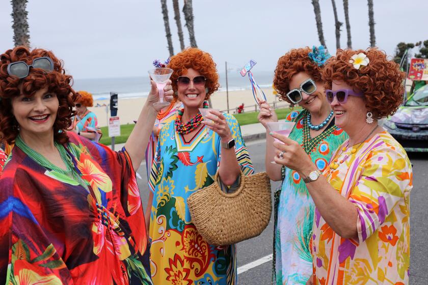 Mrs Roper Romps raise their glasses and cheer during in Huntington Beach's 120th Annual 4th of July Parade along Pacific Coast Highway in Huntington Beach on Thursday, July 4, 2024. (Photo by James Carbone)
