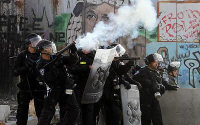 Israeli troops fire tear gas at Palestinian protesters at Qalandya checkpoint near the West Bank city of Ramallah.