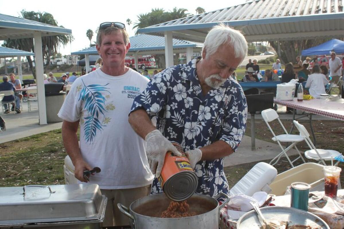 Tom Doyle and Mike Berg of Old Mission Beach Athletic Club handle the beans.