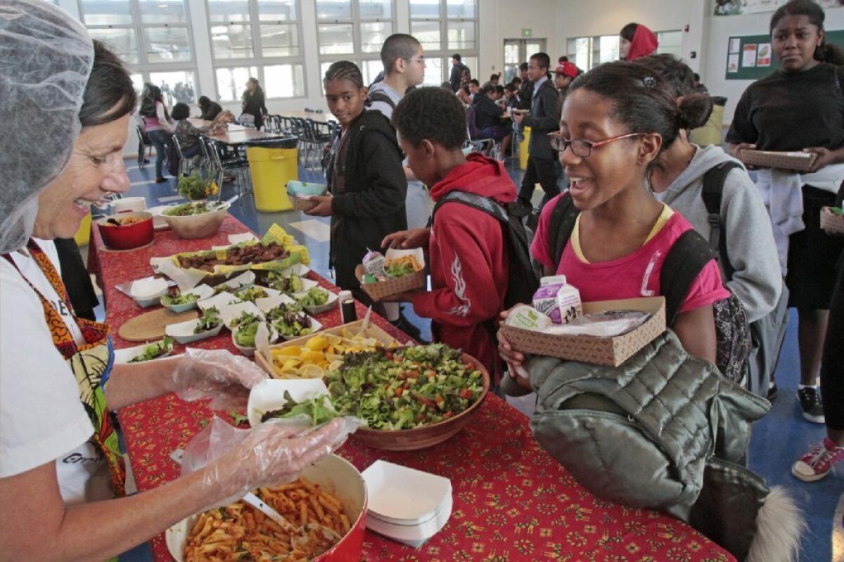 A student gets food from the garden table at lunch in Venice.