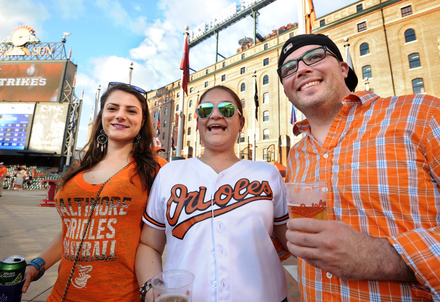 Orioles fans from left: Sara Giraldo, 29, Ellicott City; her sister Natacha Giraldo, 31, Federal Hill; and Adam Booth, 31, Federal Hill. Fans returned to Camden Yards for the first time since April 25, due to the riots and unrest in Baltimore because of the death of Freddie Gray.