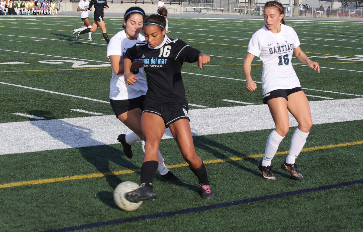 Corona del Mar's Erin Jones (16) saves the ball from going out of bounds.