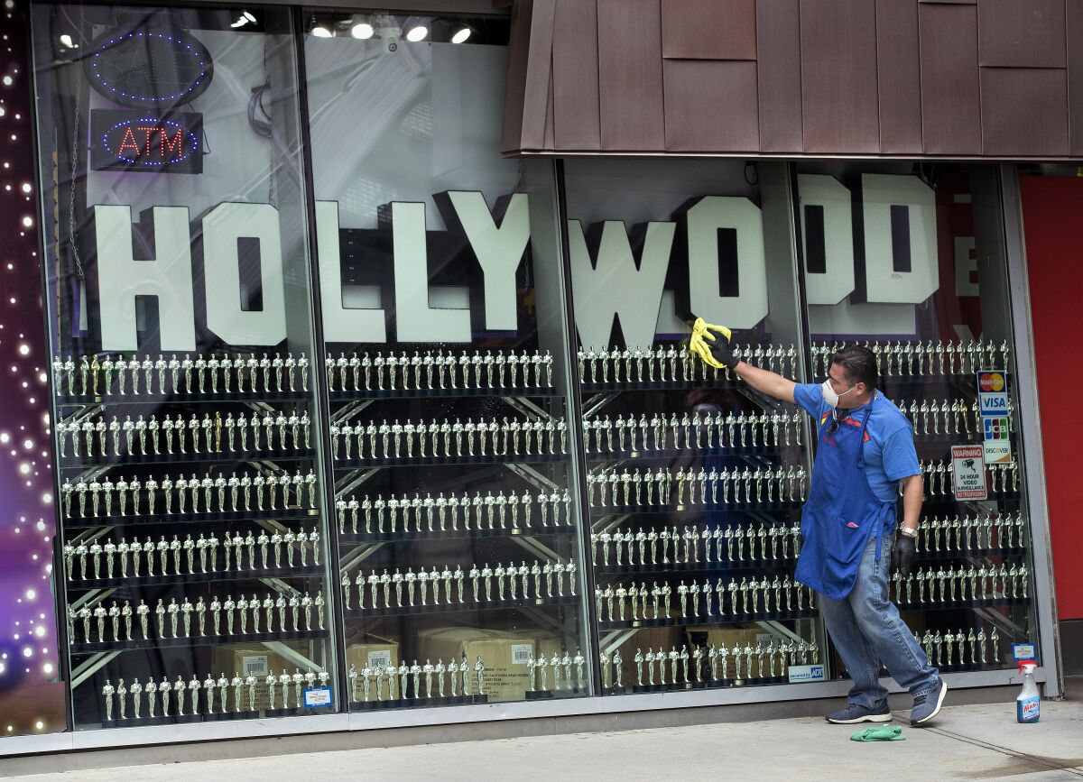 Roberto Mendez cleans the windows of a souvenir shop in Hollywood.