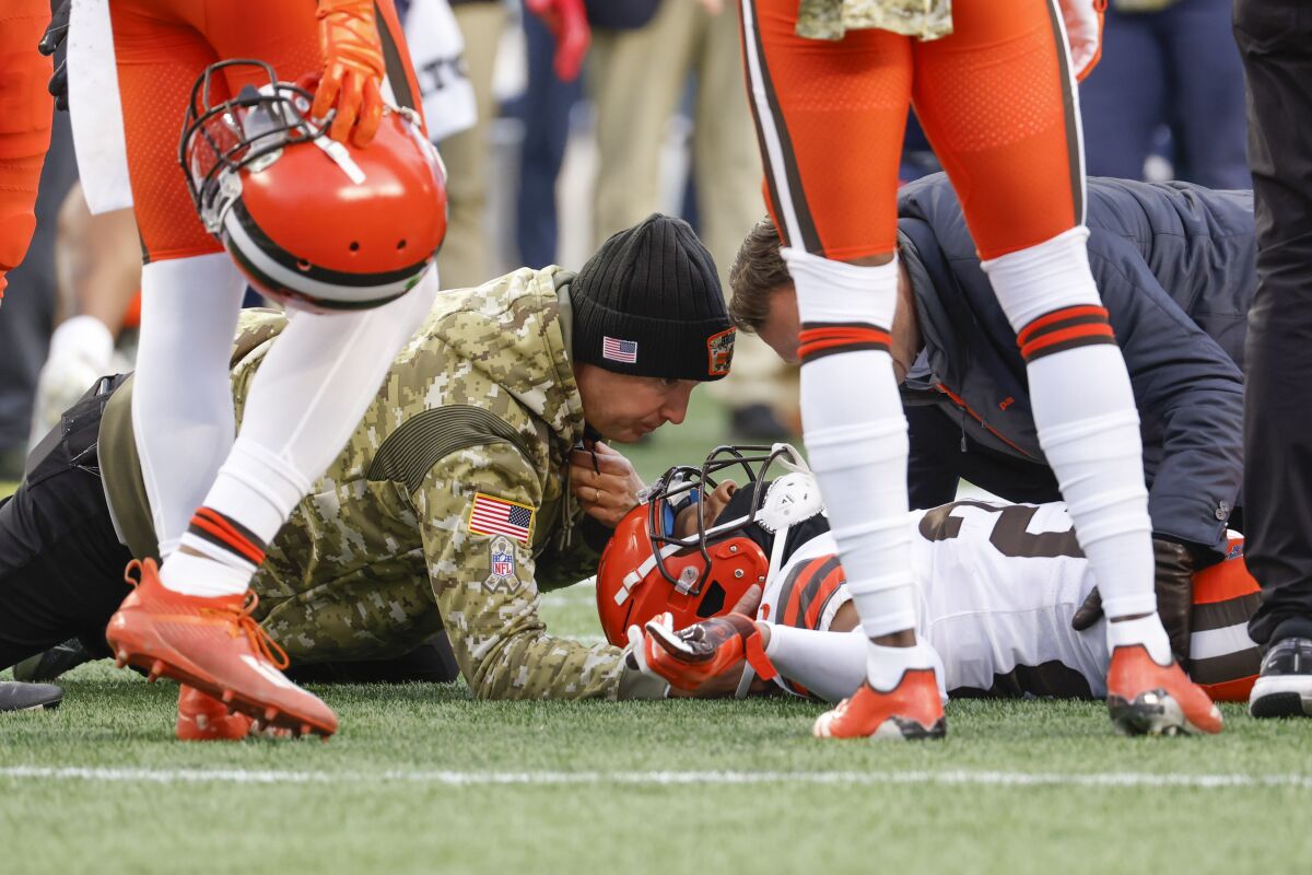Cleveland Browns cornerback Troy Hill (23) is tended to by a medical trainer after an injury during the second half of an NFL football game against the New England Patriots, Sunday, Nov. 14, 2021, in Foxborough, Mass. Hill was released from a Boston-area hospital after being treated for a neck sprain in Sunday's 45-7 loss to the New England Patriots. A team spokesman said Hill is traveling back to Cleveland on Monday, Nov. 15 following the scary moment in the closing minutes of the blowout loss.(AP Photo/Greg M. Cooper)