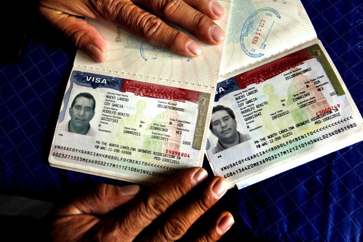 A worker shows the documents that have made it legal for him to work seasonally in North Carolina under the H-2A guest worker program. He gets a new visa each year if he and his employer meet the requirements.