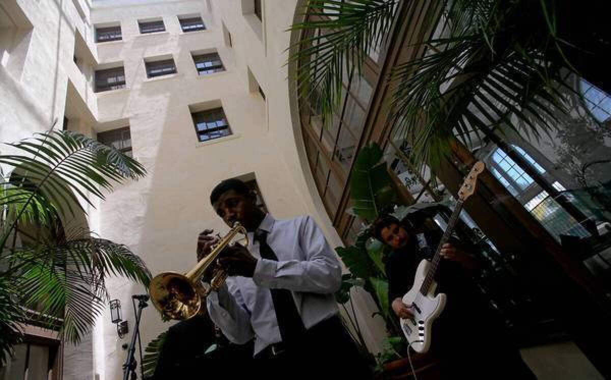 Nile Seabrooks, 17, left, and Gustavo Puga perform in the atrium of the historic Dunbar Hotel during the 18th annual Central Avenue Jazz Festival.