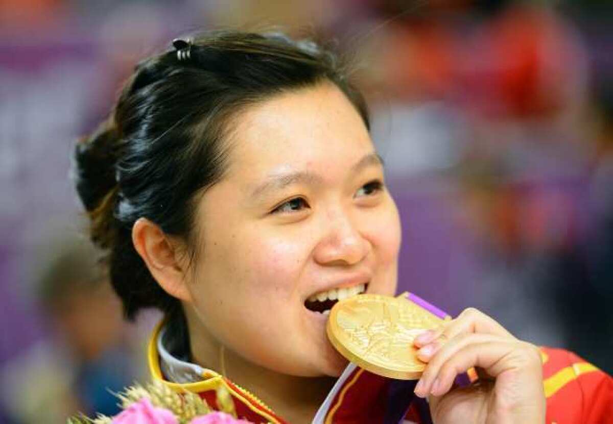 Careful, Wenjun Guo, that gold medal you are biting on is worth $708.