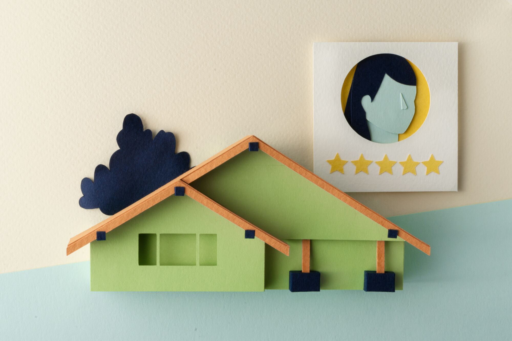 A model of a Craftsman home with a depiction of an agent review behind it.