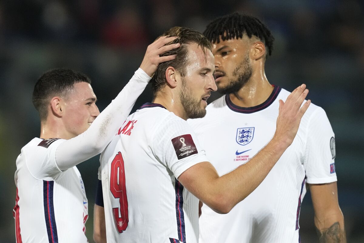 England's Harry Kane, center, celebrates after scoring his side's fifth goal during the World Cup 2022 group I qualifying soccer match between San Marino and England at Olympic Stadium, in Serravalle, San Marino, Monday, Nov. 15, 2021. (AP Photo/Antonio Calanni)