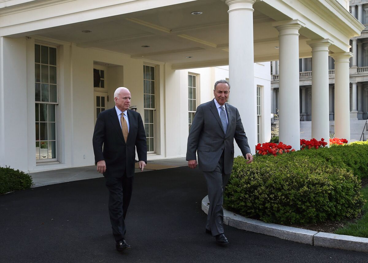 Sen. Charles Schumer (D-N.Y.) and Sen. John McCain (R-Ariz.) walk out of the West Wing of the White House after meeting with President Obama on immigration reform.